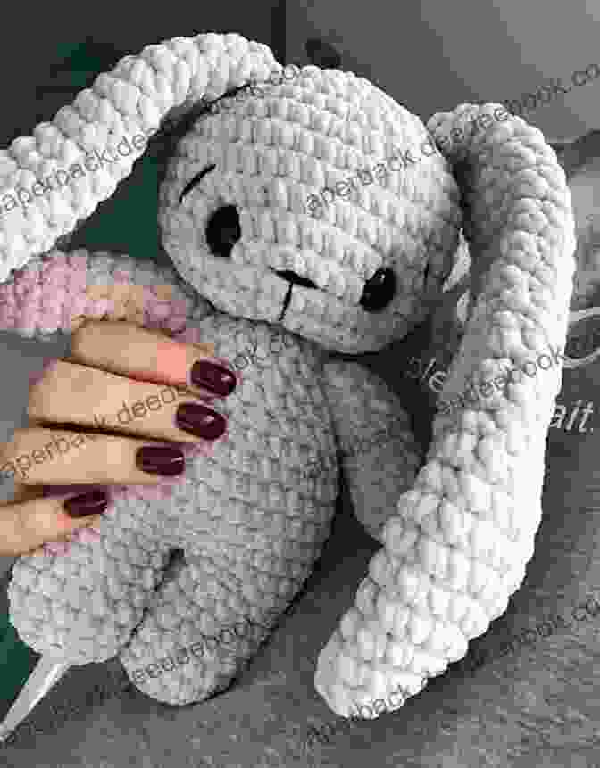 An Adorable Crocheted Baby Bunny Amigurumi With Soft And Fluffy Fur, Long Ears, And Embroidered Black Eyes. One Day Crocheting Projects For Babies: Over 15 Crochet Projects For Babies To Play Wear Snuggle (one Day Crochet Projects Crocheting Knitting Cross Crochet Patterns Baby Crochet 1)